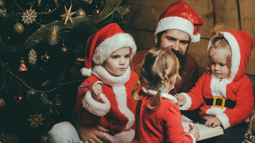 Ein Vater feiert mit seinen Kindern Weihnachten
