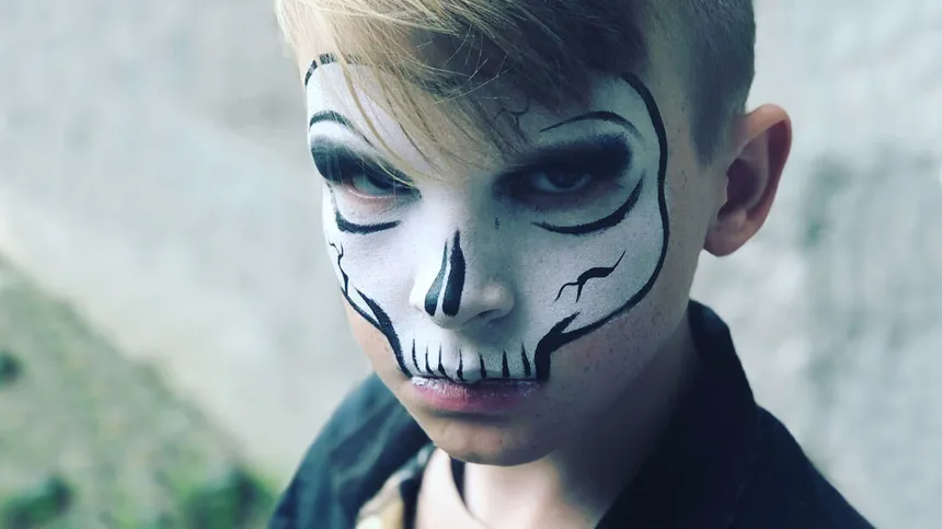 Halloween schminken: Kind als Skelett verkleidet