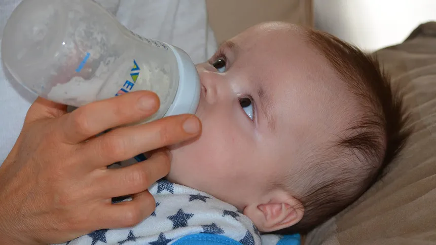 Baby trinkt aus einer Flasche