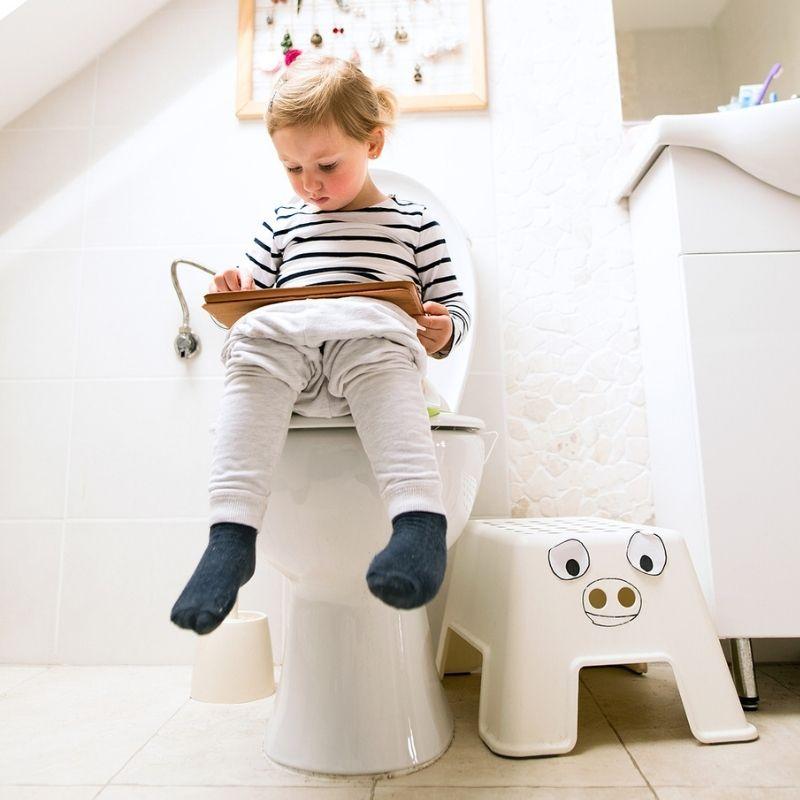 Kleines Kind sitzt auf Toilette